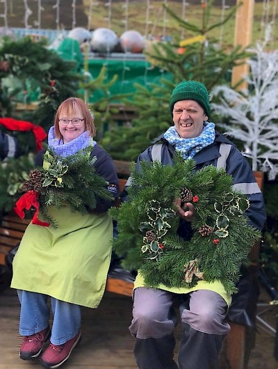 Gina and Malcolm, wreaths at the ready
