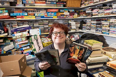 Louise sorting DVDs, games and books.
